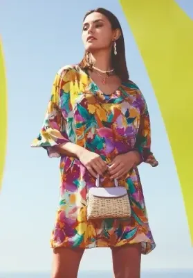 Malena Sundress by Nuria Ferrer Malena Sundress by Nuria Ferrer. The hem falls at knee length and the abstract floral print looks great. Lifestyle photo.