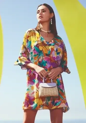 Malena Sundress by Nuria Ferrer. The hem falls at knee length and the abstract floral print looks great. Lifestyle photo.