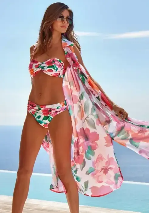 Lifestyle photo of Dalia Blass Sleeveless Shirt Dress, a poly chiffon, sleeveless dress in a pink floral pattern on white