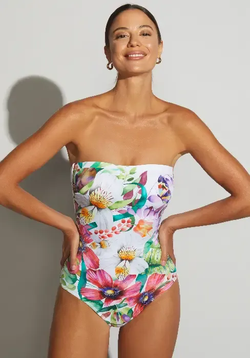 Lifestyle photo of Paraiso Orquidea Bandeau Swimsuit. The design is a floral print on a white background.
