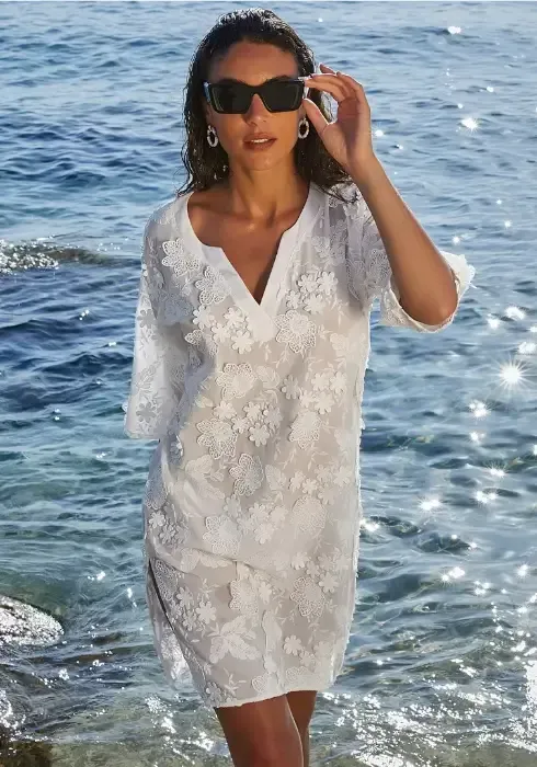 Romance Couture Tunic Dress  by Lise Charmel. The fine cotton rich fabric is embellished with amazing 3D floral embroidery. Lifestyle photo.