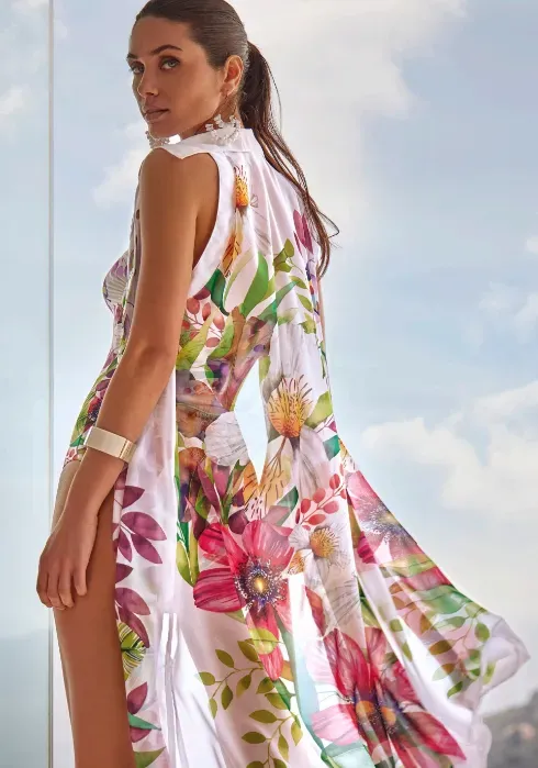 Lifestyle photo of Roidal Paraiso Faida Sleeveless Shirt Dress in a lightweight fabric with a pink floral pattern on white.