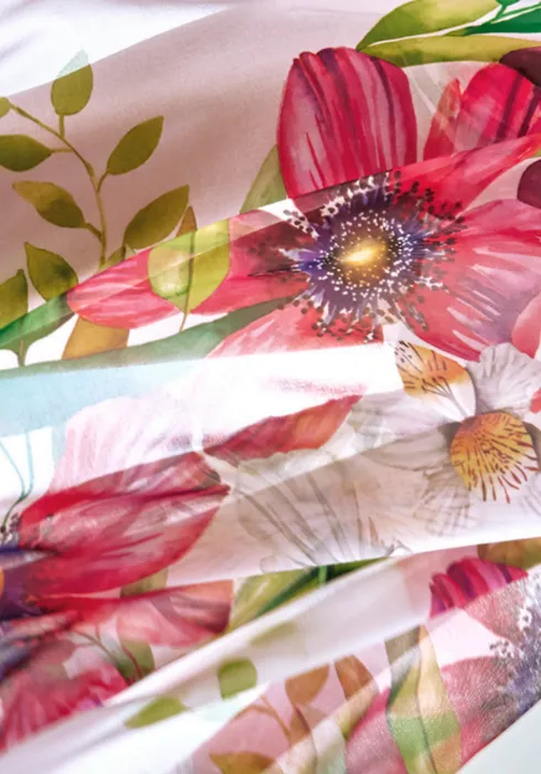 Roidal Paraiso Robin Pareo. A flowing sarong in a colourful floral print on a white background.