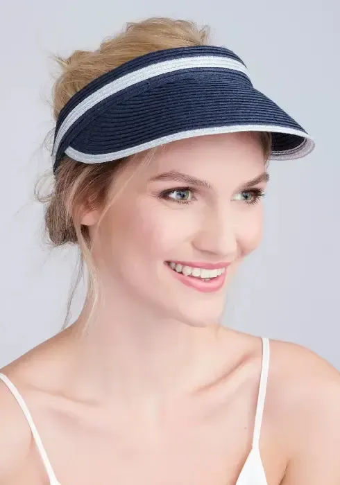 Lifestyle photo of Coben Visor in navy blue with white trim.