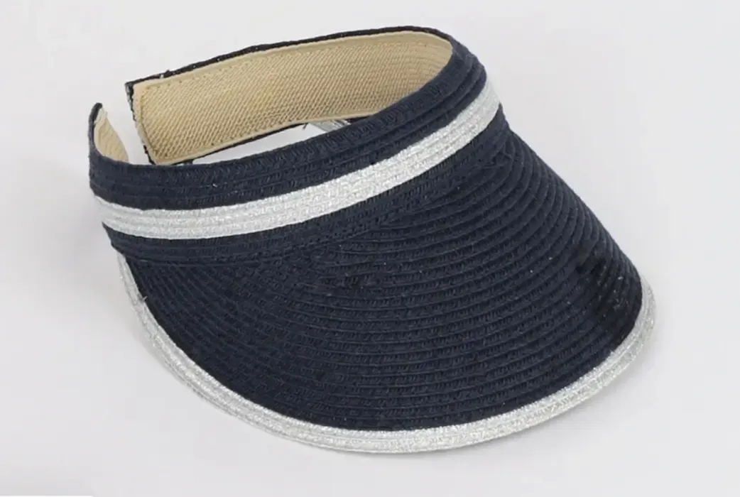 Lifestyle photo of Coben Visor in navy blue with white trim.