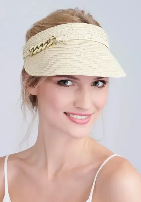 Lifestyle photo of Khari Visor in natural woven tone and gold links to the side.