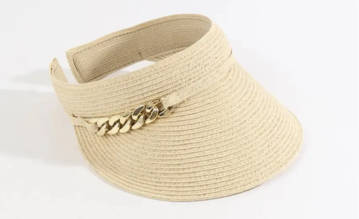 Lifestyle photo of Khari Visor in natural woven tone and gold links to the side.