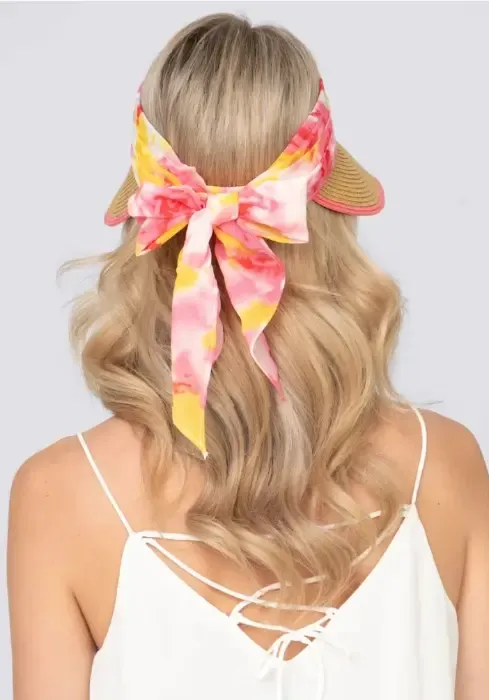 Lifestyle photo of Misha Visor in Natural & Pink. A woven visor with pink floral material.