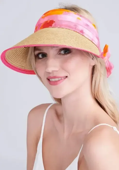 Lifestyle photo of Misha Visor in Natural & Pink. A woven visor with pink floral material.