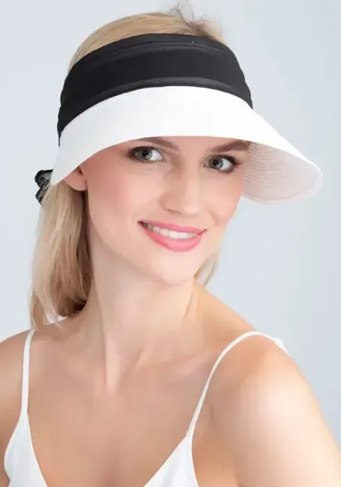 lifestyle photo of Augusta Visor in White & Black a white visor with black material bow