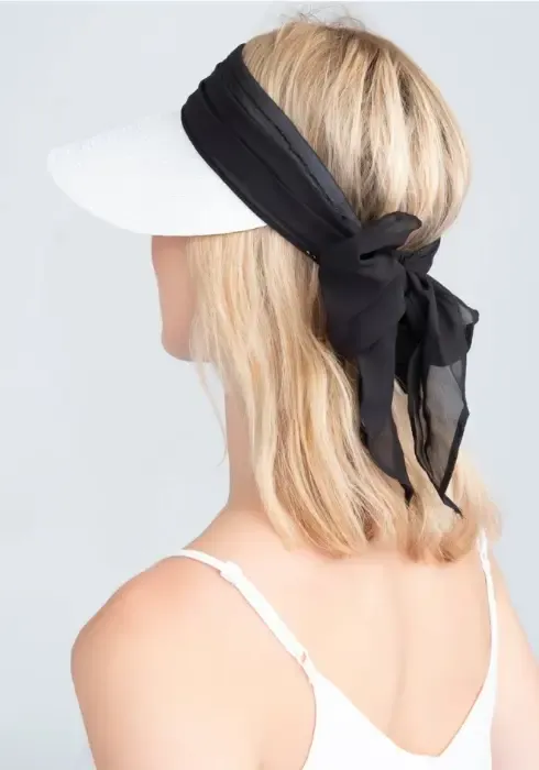 lifestyle photo of Augusta Visor in White & Black a white visor with black material bow