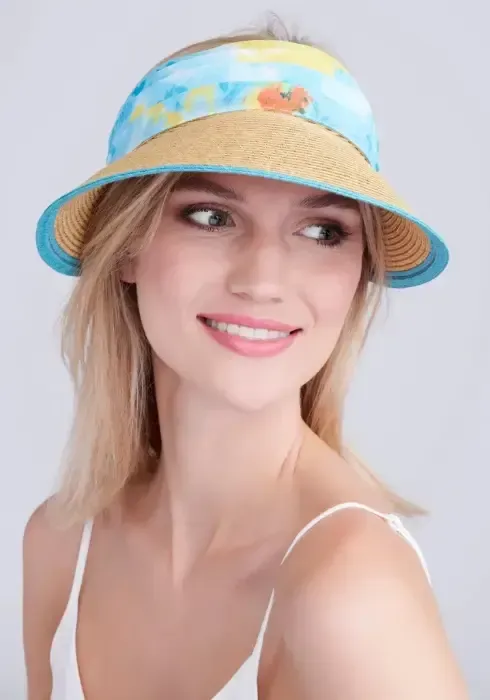 Lifestyle photo of Misha Visor in Natural & Turquoise. A woven visor with turquoise floral material.