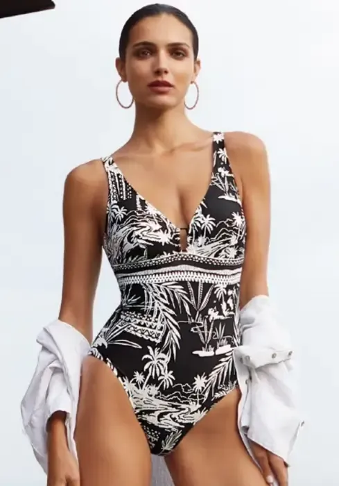 A model wearing a Nuria Ferrer Bahia Comfy swimsuit in a monochrome tropical print.
