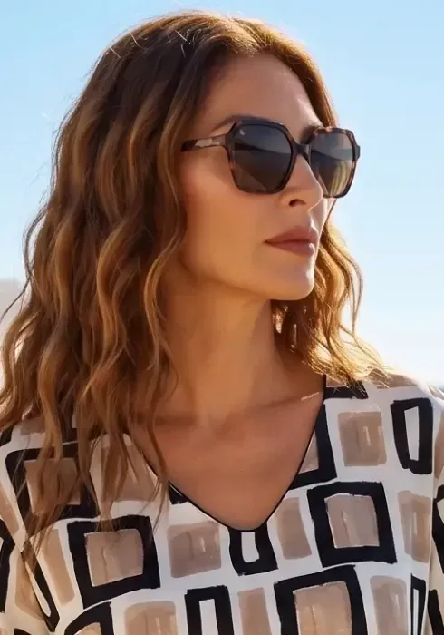 Close up of a model wearing a pair of Athena Tortoiseshell Polarised Reading Sunglasses with Nuria Ferrer Geo Short Kaftan