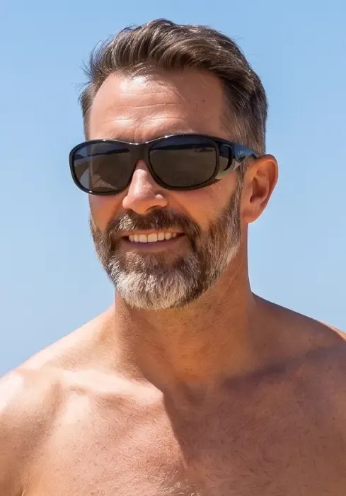 Close up of a model wearing Goodlookers Black Coverspecs Suglasses 