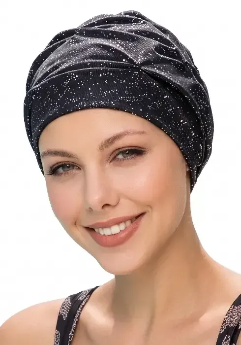 Close up of a  model in a studio setting wearing a Fashy Black Silver Glimmer Swim Turban