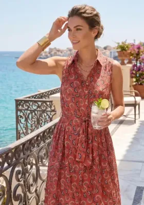 A model wearing a Rich Terracotta Shirt Dress by Dolores Cortés with a tie waist belt. Sleeveless dress in a modern print.