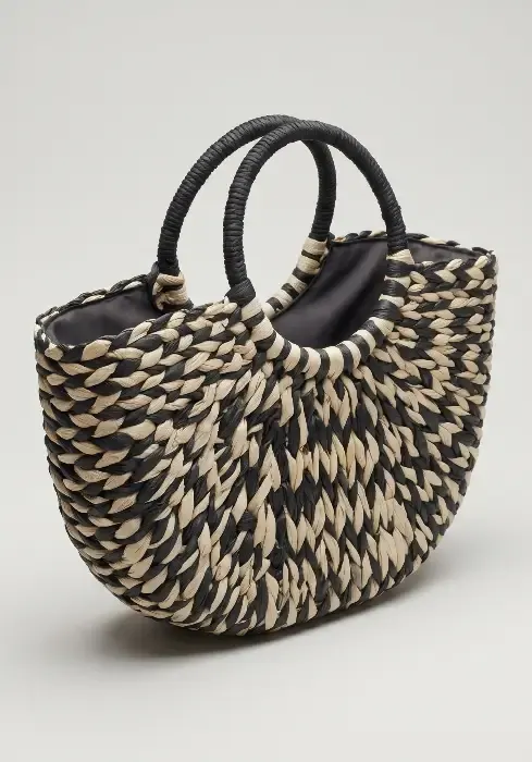 A model carries a Pia Rossini Monaco Half Moon tote bag. Lightweight, easy to carry tote with interior zip for security.