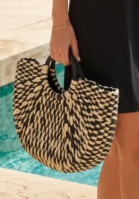 Monaco Half-moon Bag A model carries a Pia Rossini Monaco Half Moon tote bag. Lightweight, easy to carry tote with interior zip for security.
