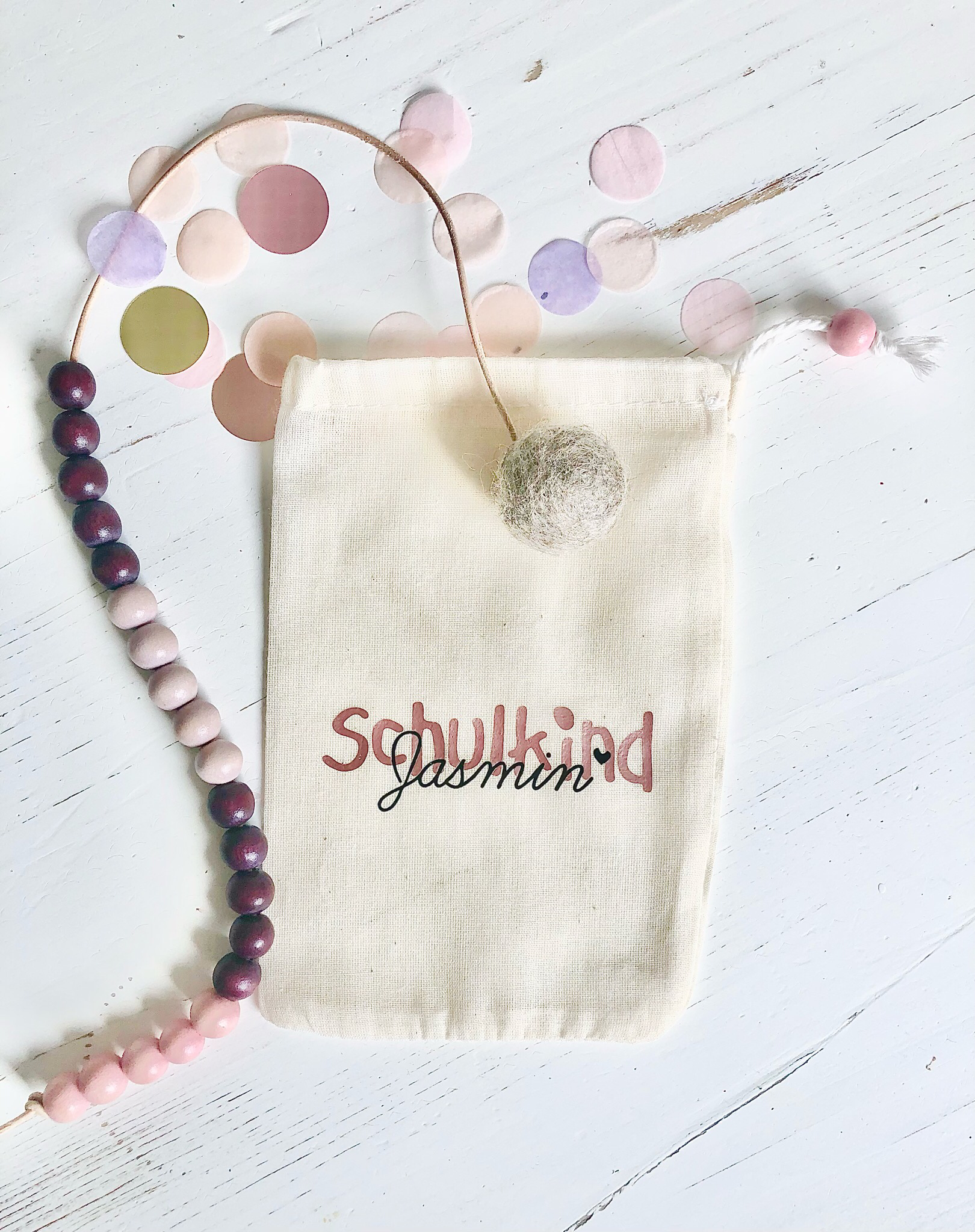 Rechenkette aus Perlen in Rosa- und Lilatönen