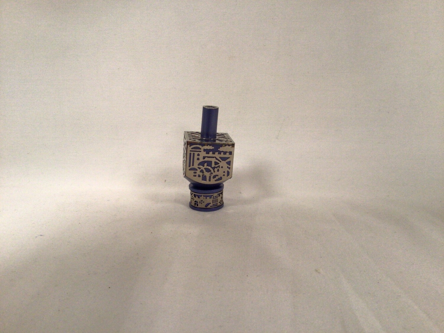 Anodized Blue Dreidel with Jerusalem Metal  Cutout on Stand