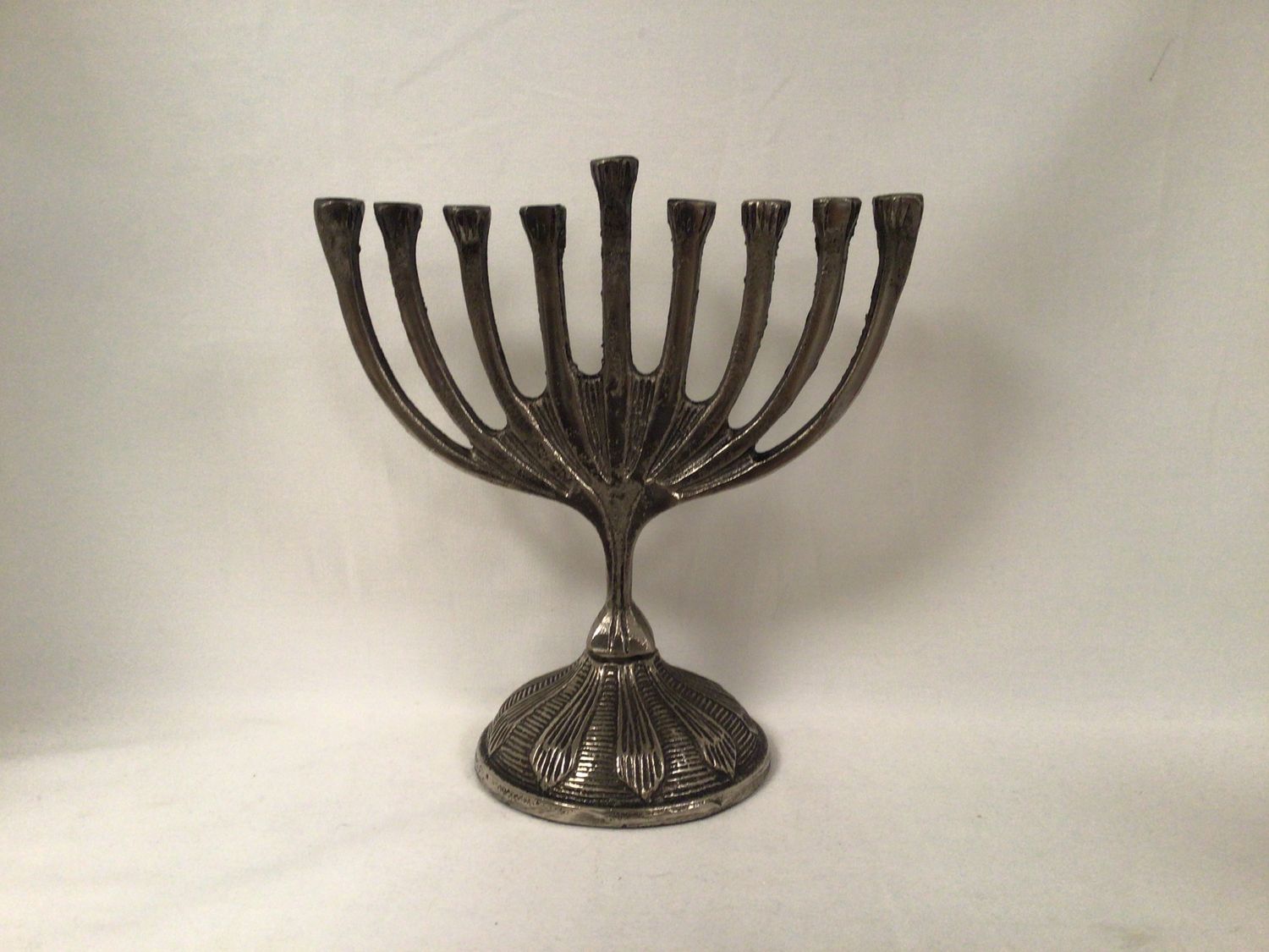 Metal Menorah with Decorative Designs on Base