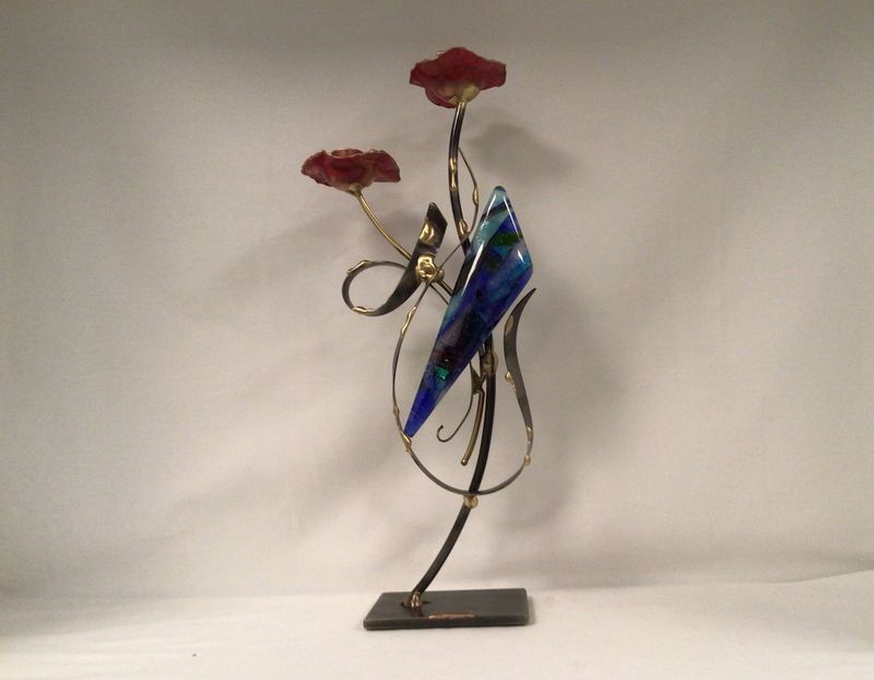 Flowering candlesticks with metal form and colorful glass accent.