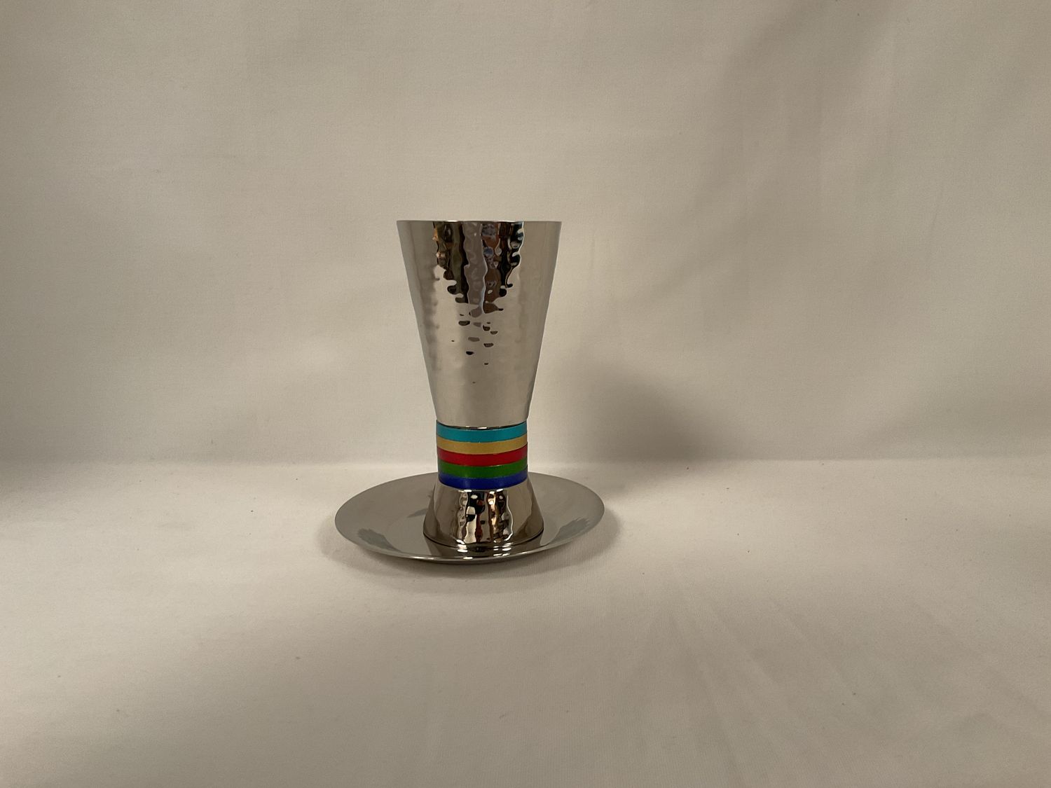 Hammered Cone Shaped Kiddush Cup with Multicolor Rings on Tray Hammered Cone Shaped Kiddush Cup with Multicolor Rings on Tray