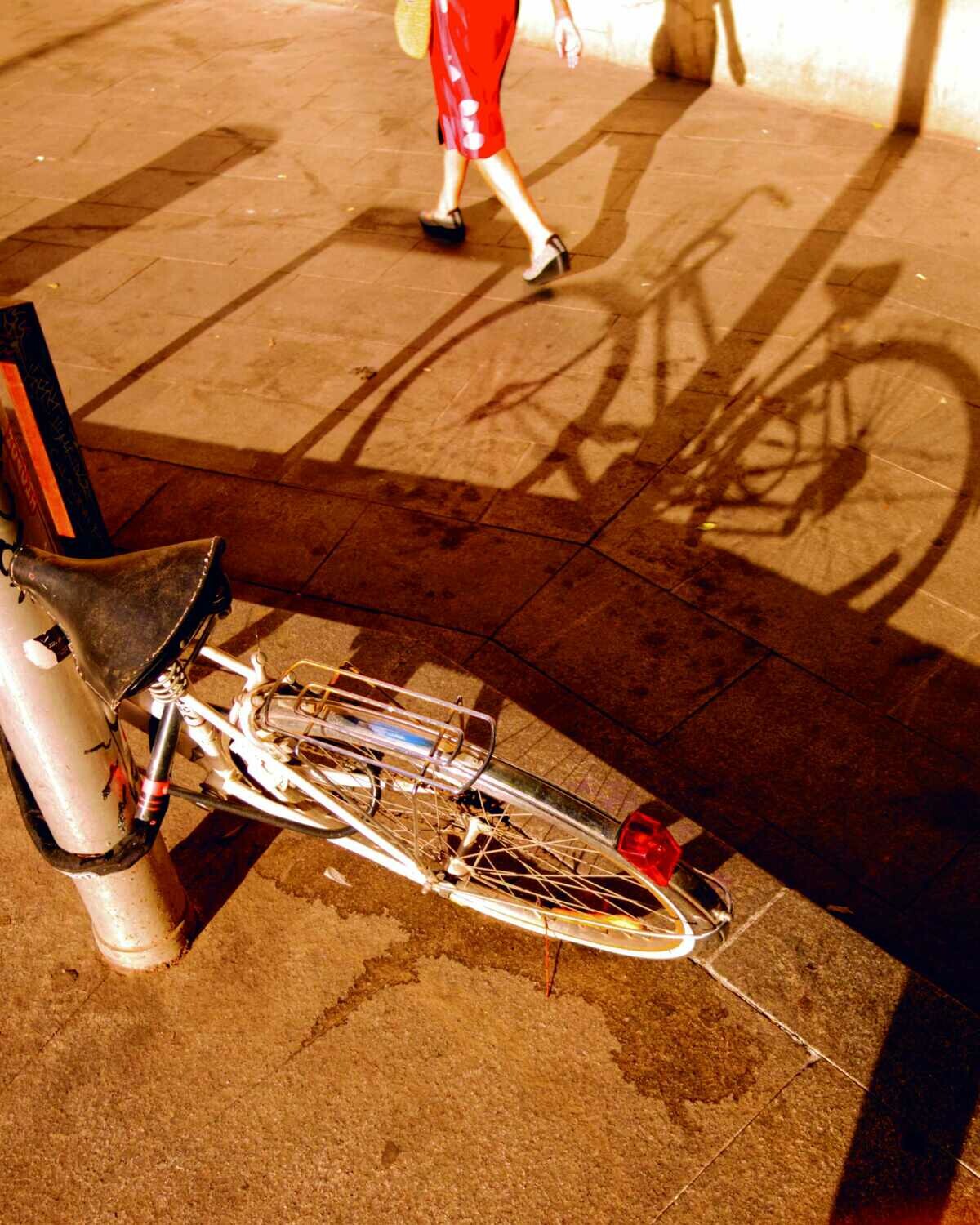 Bike shadow and woman passing by.Universo Fran.