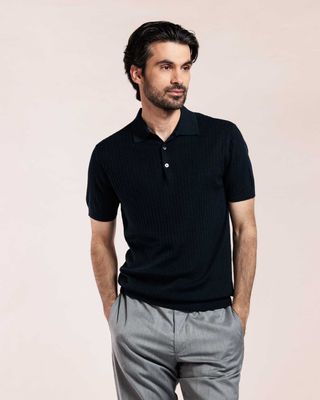 Man draagt navy ribgebreide polo van Thomas Maine met korte mouwen
