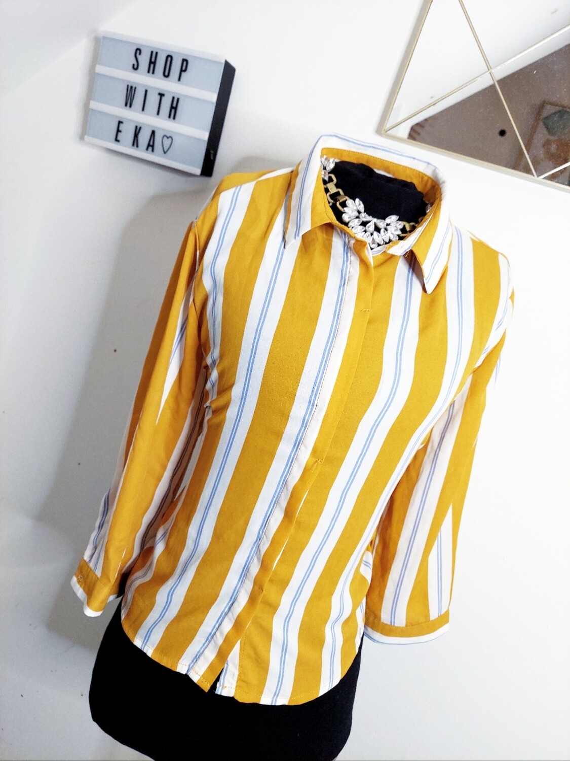 used yellow and white button up blouse