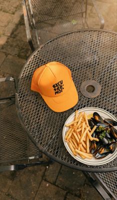Clare V. Trucker Hat in Excusez Moi Marigold