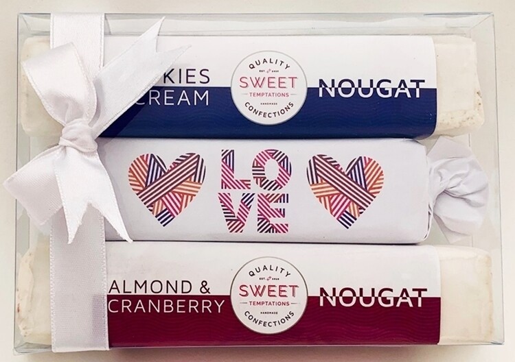 One soft caramel toffee, beautifully wrapped and packaged in Love themed wrapper with two assorted luxury nougats, packaged in a gift box with ribbon.