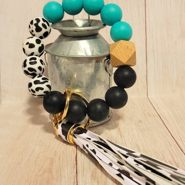 The Wristlet Bar Teal Cow Print Keychain with Tassel