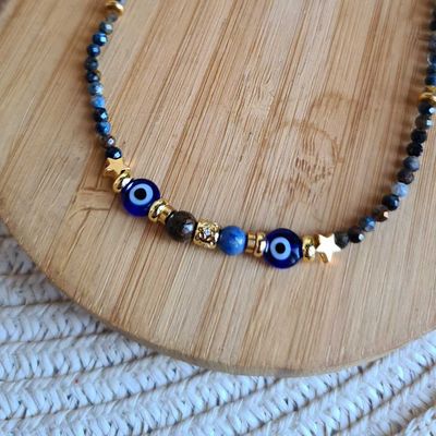 Gargantilla de Pietersita y ojo turco con estrellas de plata y acero bañada en oro.