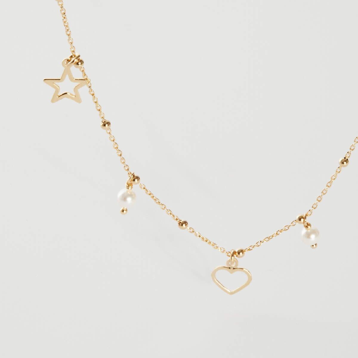 Collar corto motivos color perla bañado en oro