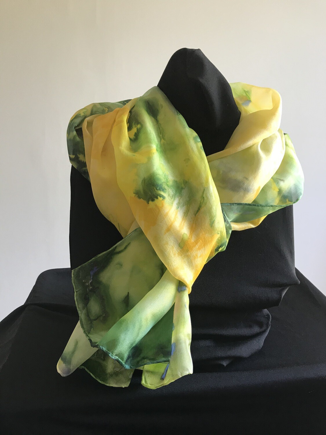 Hand painted 100% silk scarf in bright yellows and greens.