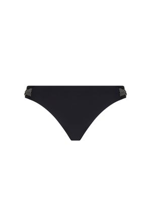 Elegante Lise Charmel Swim Horizon Boreal bikinislip in diepzwart, met verfijnde afwerkingen en een lage taille, liggend tegen een neutrale achtergrond.