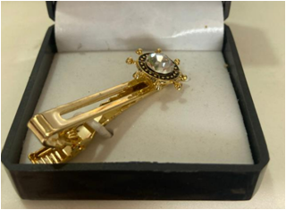 stone tie pin with ship wheel 