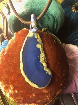 Bright blue agate slice on brown leather cord