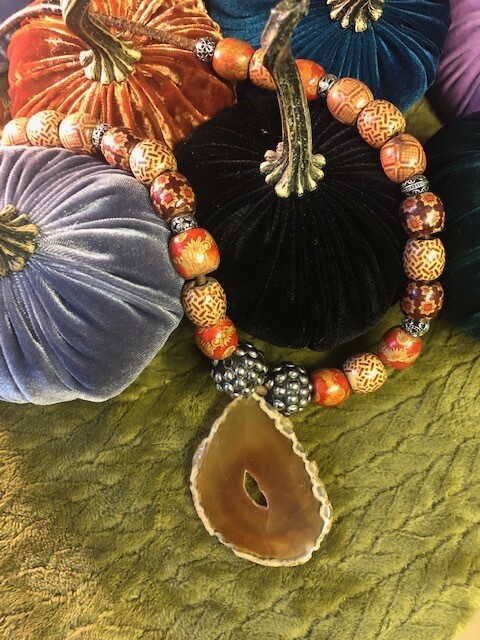 Large orange agate slice on a beaded necklace