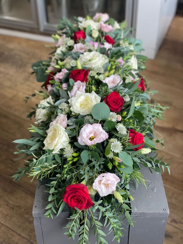 Casket spray red, white and soft pink