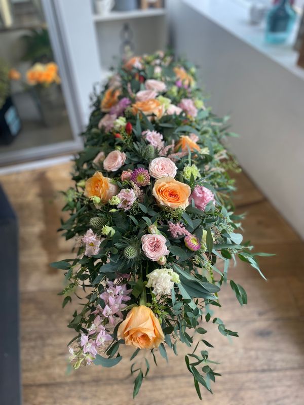 Casket spray soft orange and pinks