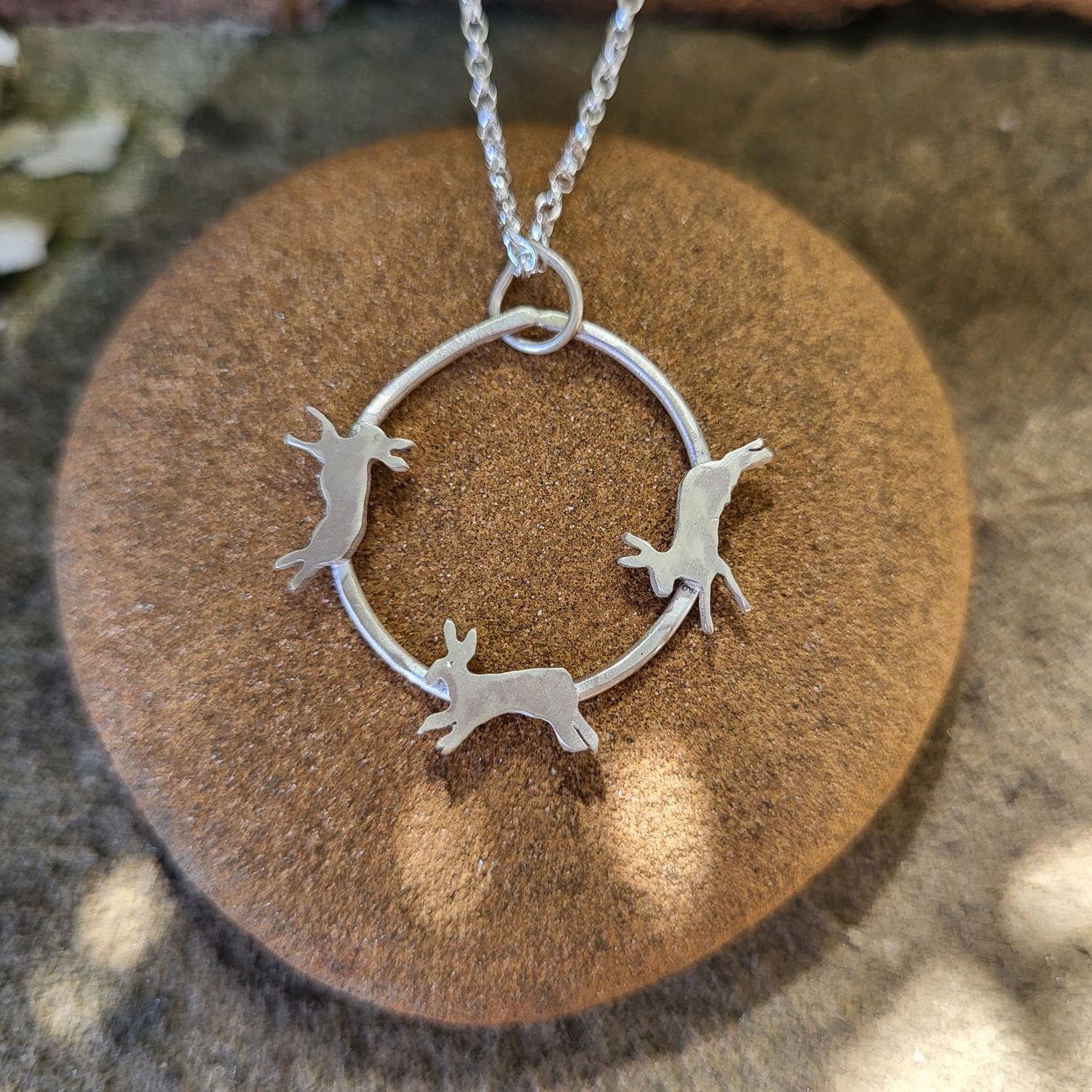 N1793 Trio of Chasing Hares pendant