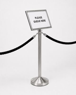 Side angle view of chrome A3 landscape sign holder on queue post showing 15° tilt
