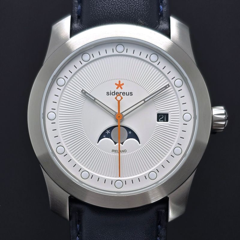 Newgrange Moon Phase with a Brushed Finish and a Quartzite White Dial 15/50 Newgrange Moon Phase with a Brushed Finish and a Quartzite White Dial 15/50