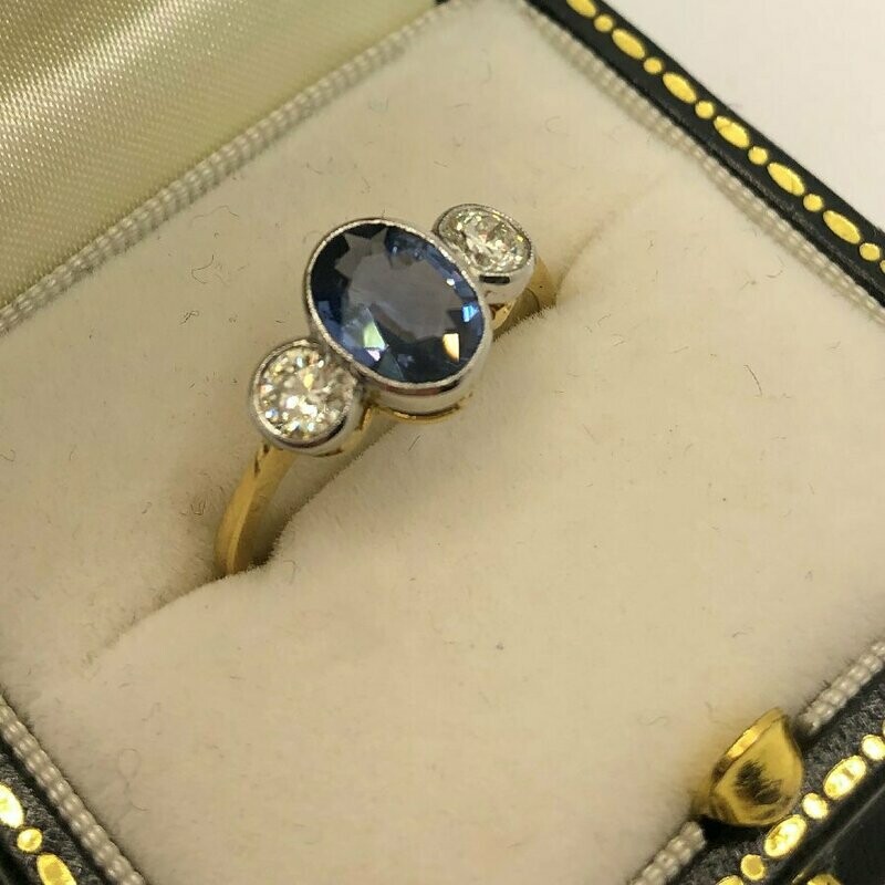 18ct gold three stone 1.30ct sapphire and .50ct diamond ring