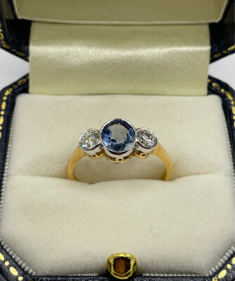 Sapphire And Diamond Three Stone Ring In An 18ct White And Yellow Gold Rub Over Setting.