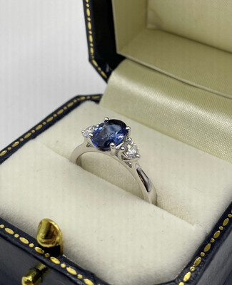 Platinum Three Stone Ring With 1.40ct Sapphire And A Brilliant Cut Diamond On Either Side