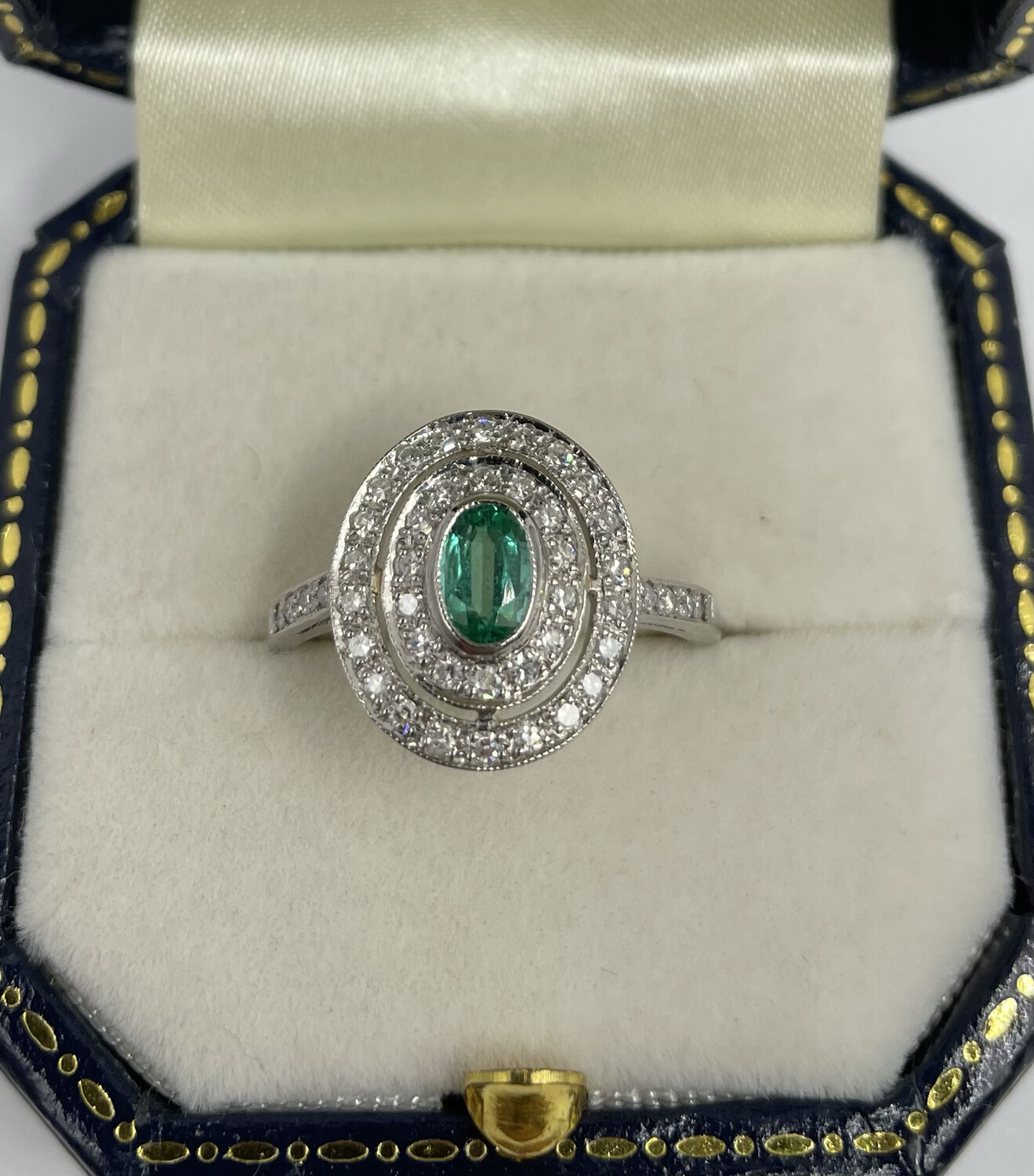 Platinum Oval Emerald And Diamond Double Halo Ring In Art Deco Style.